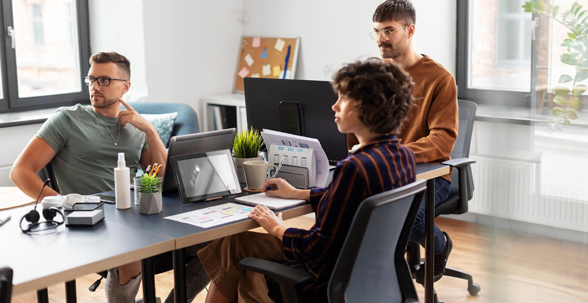 Home Creative team working through layout options on a studio desk